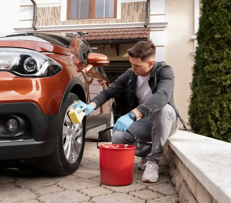 Lavage auto à domicile Baron-sur-Odon : professionnel intervenant sur un véhicule